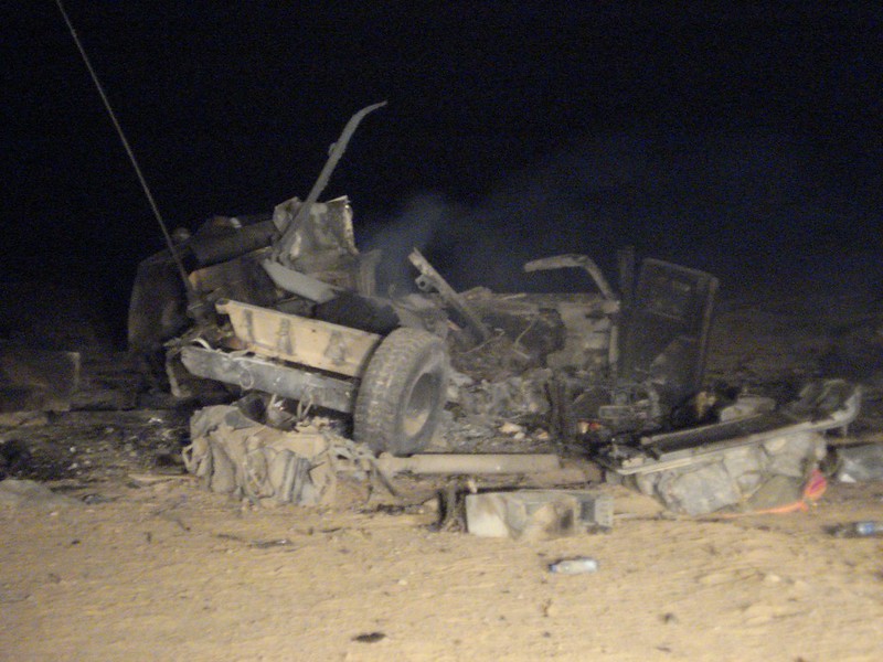 The destroyed vehicle after the IED blast